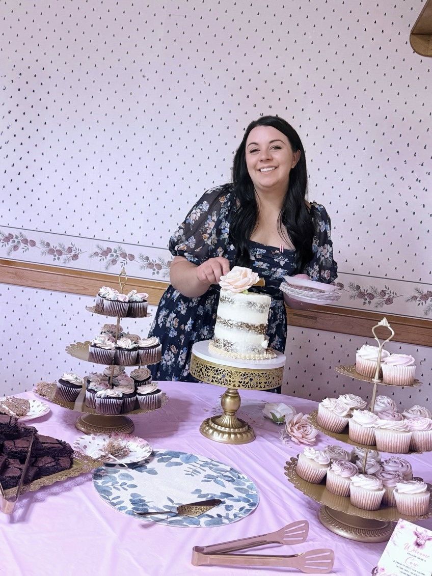 Arielle behind a dessert table