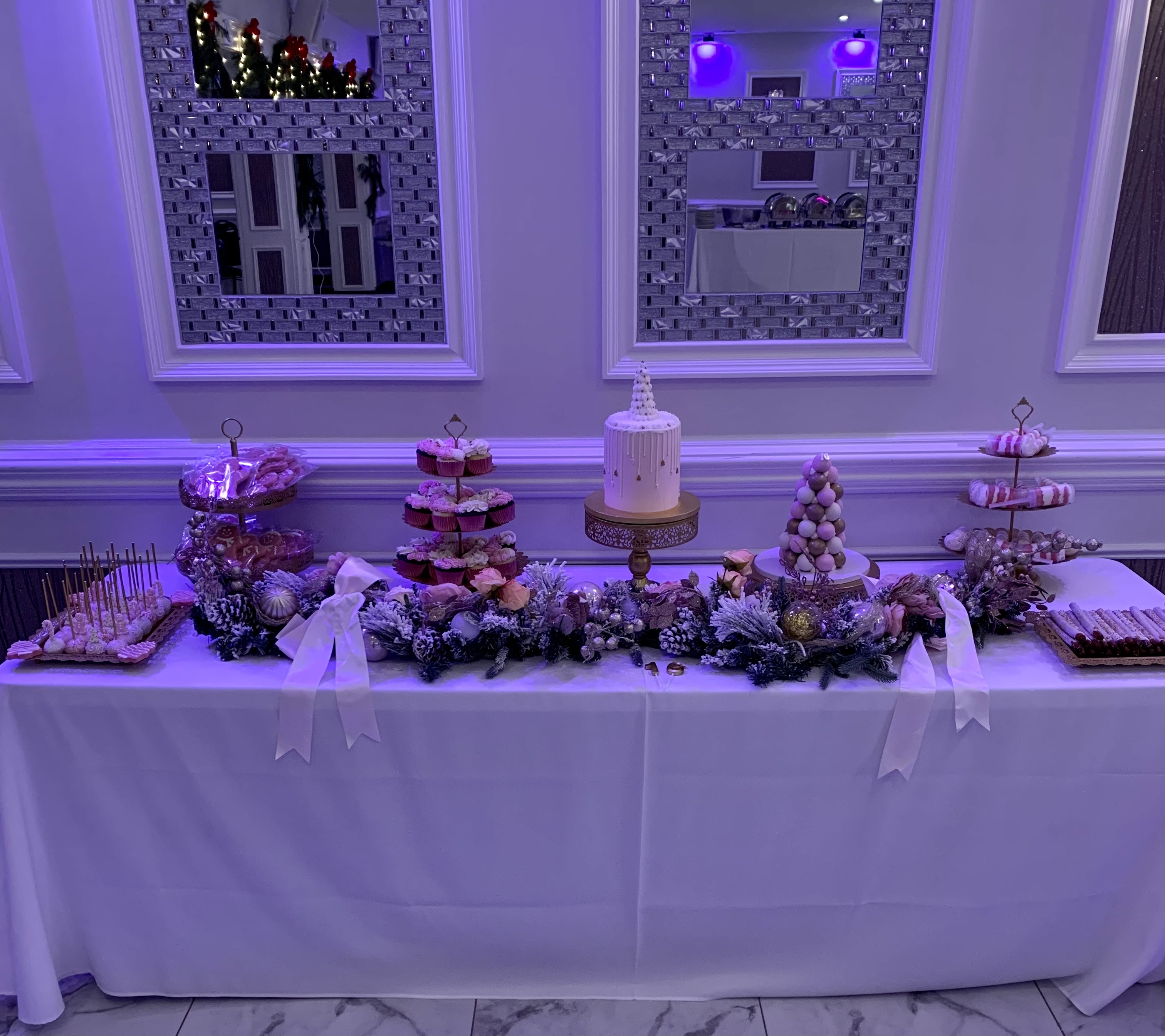 Coordinated dessert table with cake, cupcakes, cake pops, cookies, and display pieces